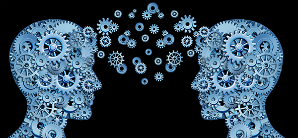 Two human heads facing each other, consisting of blue cogwheels, exchange information in the form of floating blue cogwheels